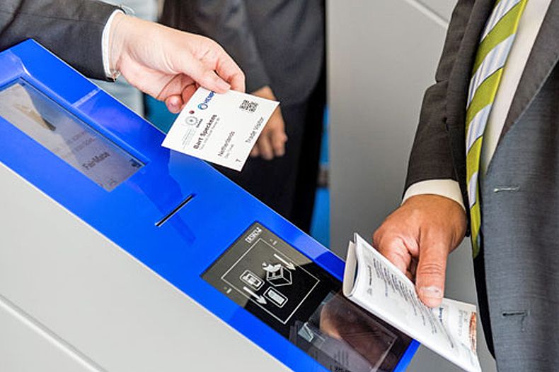 Two hands holding tickets on ticket scanner